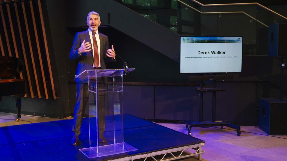 Man standing on a stage giving a speech